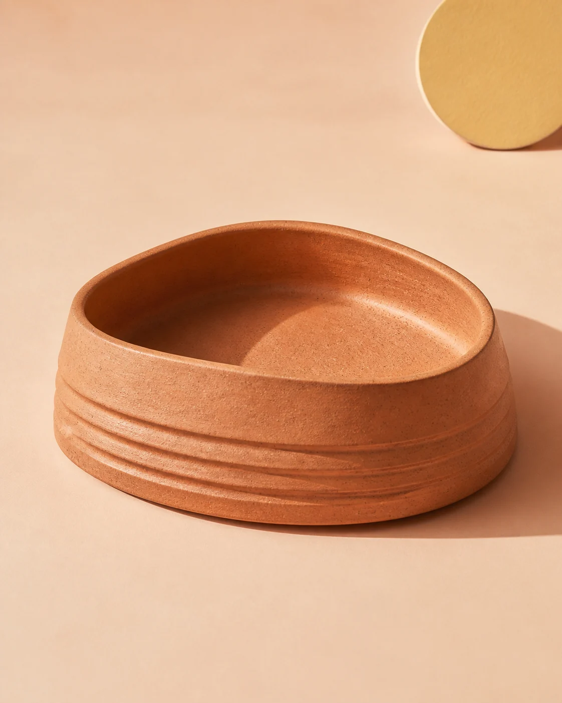 Terracotta Ripple Bowl on a pale peach studio backdrop